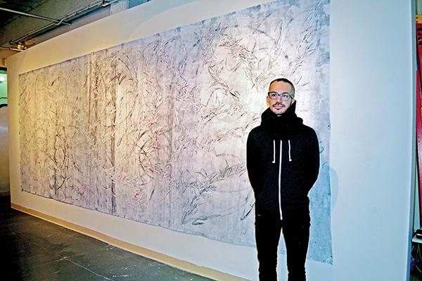 Oyama Enrico Isamu Letter, the artist, with one of his murals. Photo by Dakota Santiago