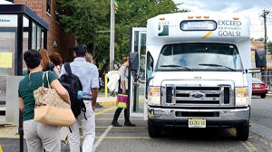 Students board a shuttle at the West Side Ave parking lot. (Photo by Dakota Santiago)
